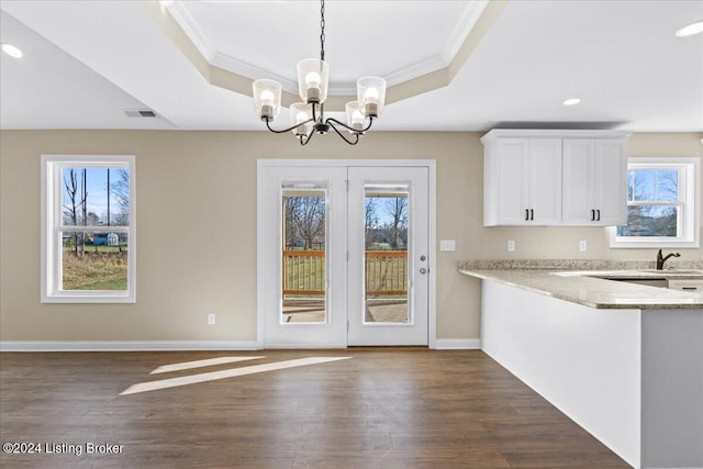 kitchen featuring white cabinets, decorative light fixtures, dark hardwood / wood-style floors, and an inviting chandelier