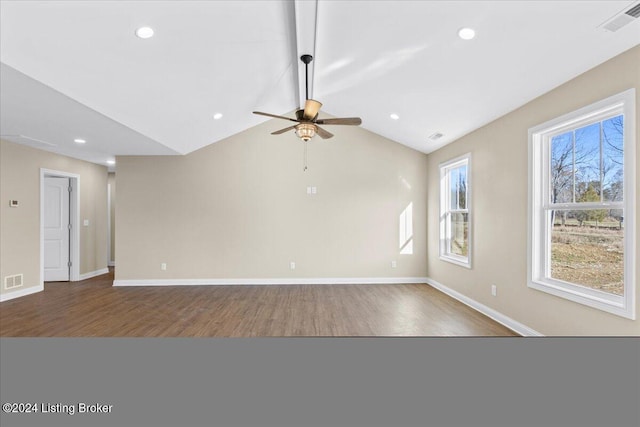 unfurnished living room with hardwood / wood-style floors, ceiling fan, and vaulted ceiling