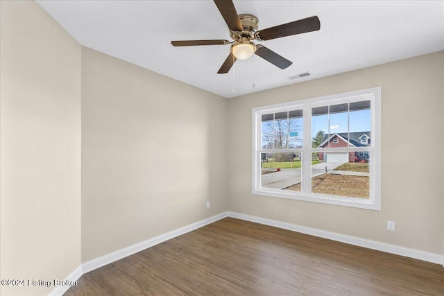 spare room with hardwood / wood-style floors and ceiling fan