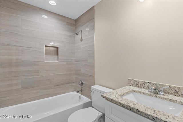 full bathroom featuring vanity, toilet, and tiled shower / bath combo