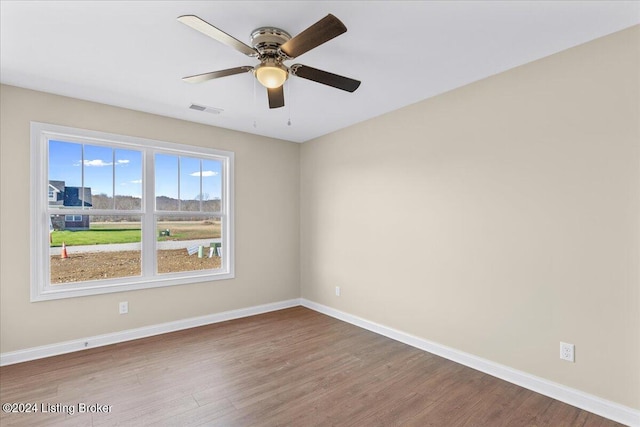 empty room featuring hardwood / wood-style floors and ceiling fan