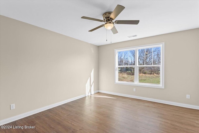 spare room with ceiling fan and hardwood / wood-style floors