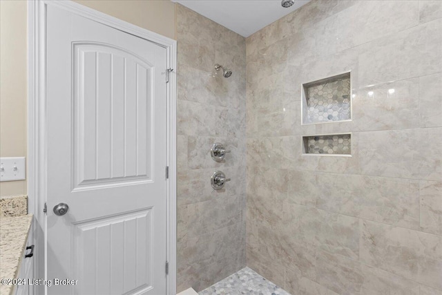 bathroom featuring vanity and a tile shower