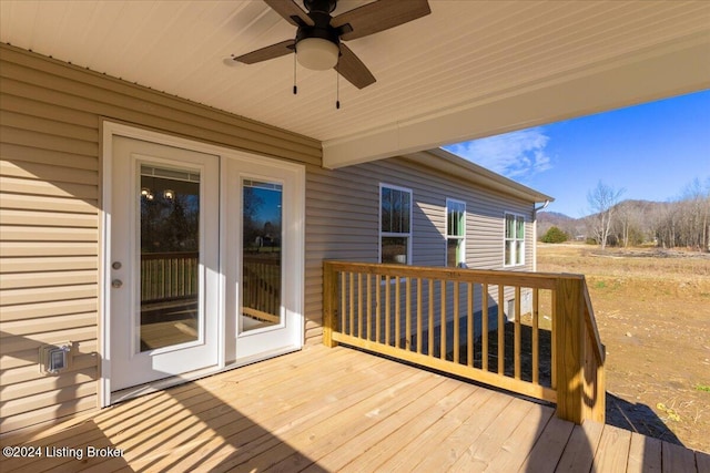 wooden terrace featuring ceiling fan