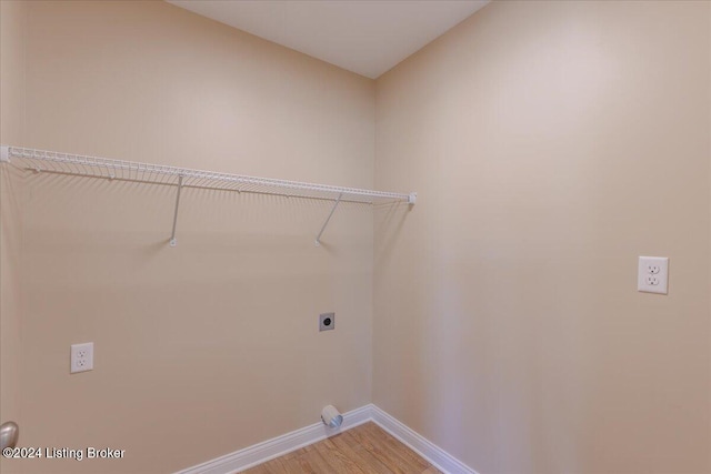 laundry area with electric dryer hookup and hardwood / wood-style flooring