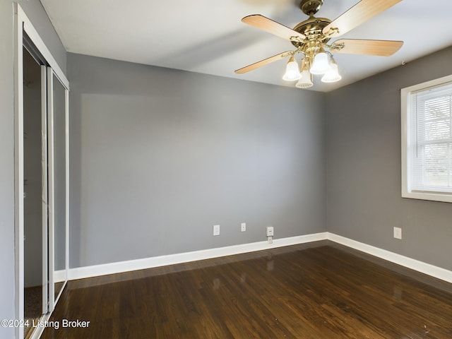 unfurnished bedroom with hardwood / wood-style floors, a closet, and ceiling fan