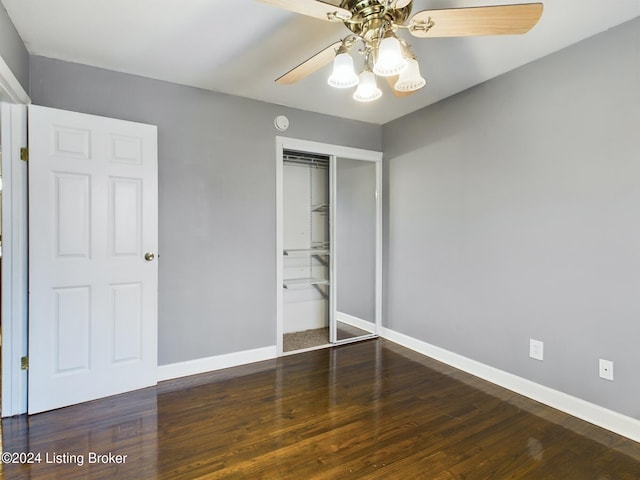 unfurnished bedroom with a closet, ceiling fan, and dark hardwood / wood-style flooring