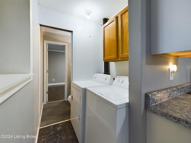 clothes washing area featuring cabinets and independent washer and dryer