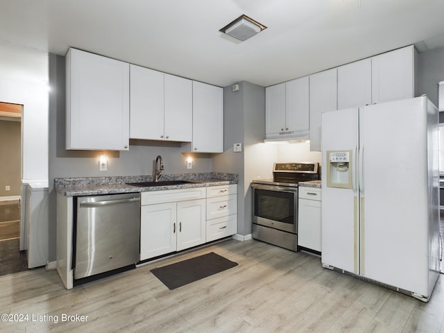 kitchen featuring white cabinetry, sink, stainless steel appliances, light stone counters, and light hardwood / wood-style flooring