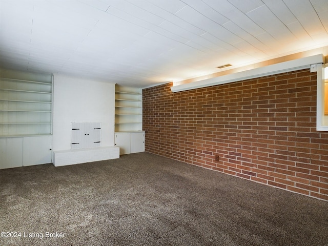 interior space with carpet flooring and brick wall