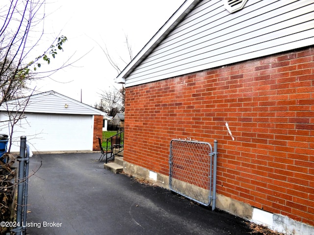 view of side of home with an outdoor structure and a garage