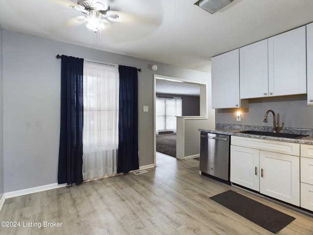 kitchen featuring stainless steel dishwasher, light wood-type flooring, white cabinetry, and sink