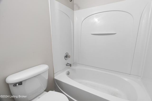 bathroom featuring shower / bathtub combination and toilet