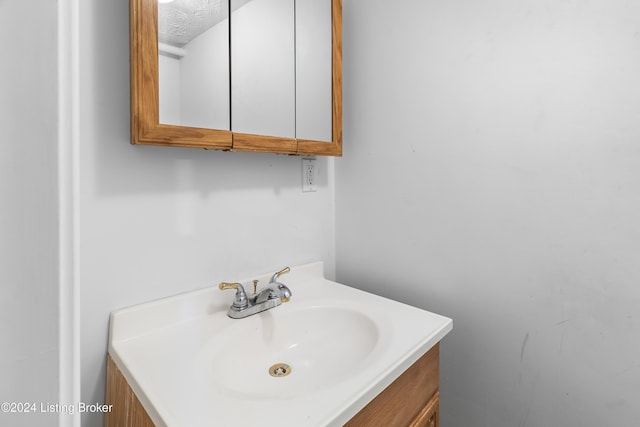 bathroom featuring vanity and a textured ceiling