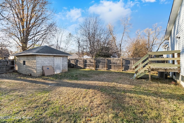 view of yard with a wooden deck and a shed