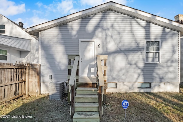 rear view of property featuring central AC unit