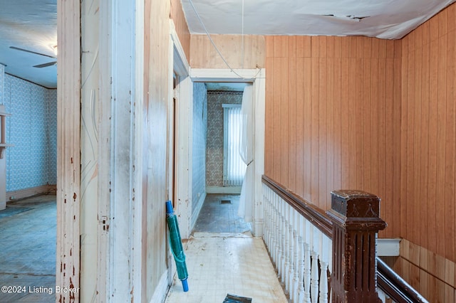 hallway with wood walls