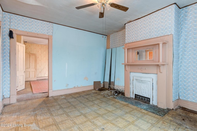 unfurnished living room featuring ceiling fan and a textured ceiling