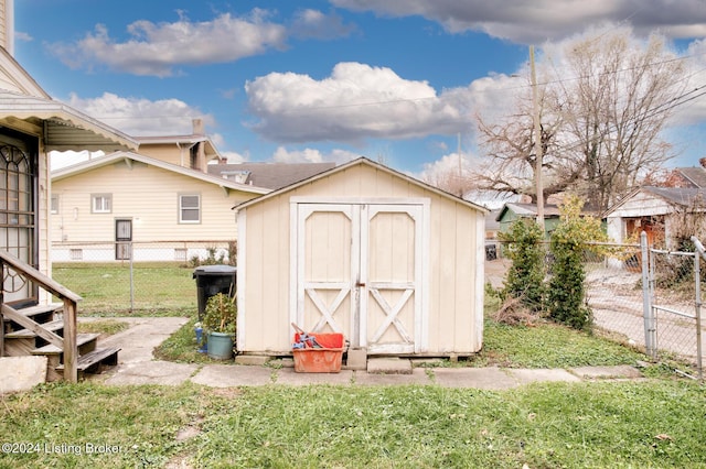 view of outbuilding with a yard