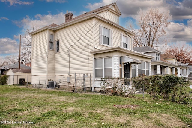 view of side of property with a lawn and central air condition unit