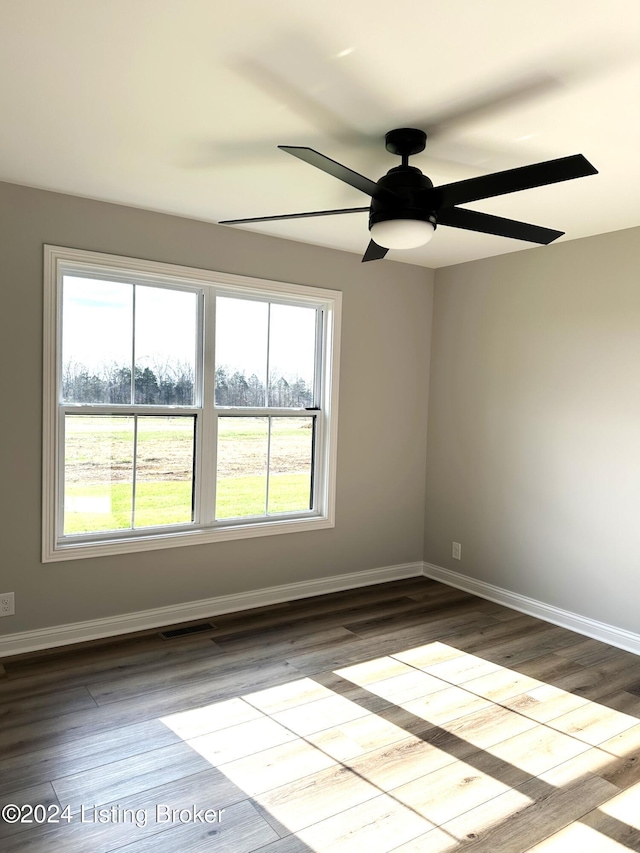 unfurnished room featuring hardwood / wood-style floors and ceiling fan