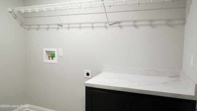 laundry room with hookup for an electric dryer, cabinets, and washer hookup