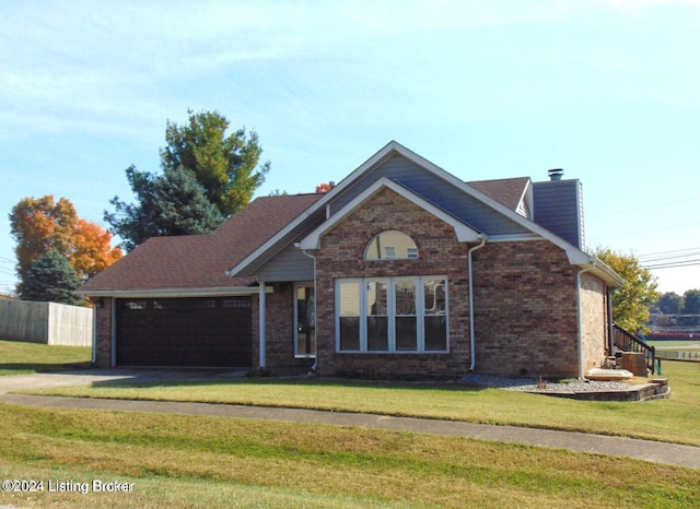 view of front facade with a front yard and a garage