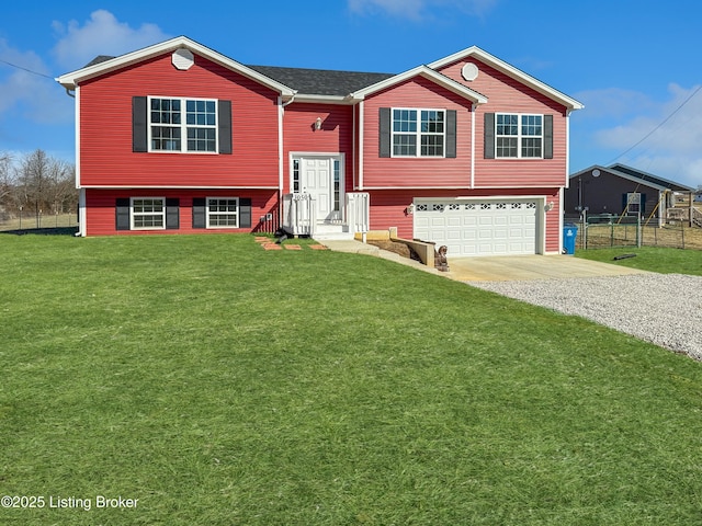 split foyer home featuring a garage and a front yard