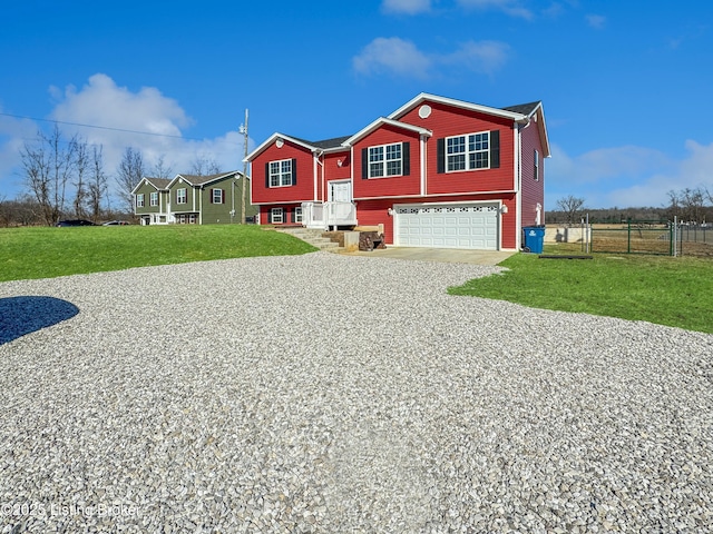 split foyer home with a garage and a front lawn