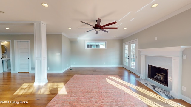 unfurnished living room featuring french doors, light hardwood / wood-style flooring, ceiling fan, and ornamental molding