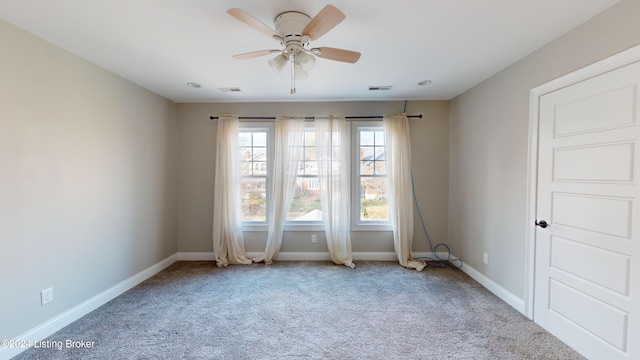 carpeted empty room featuring ceiling fan