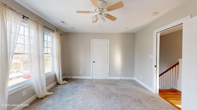 empty room with ceiling fan and light hardwood / wood-style floors