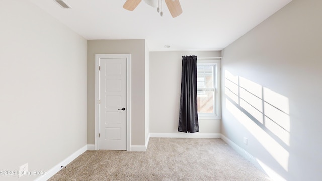 empty room featuring light carpet and ceiling fan