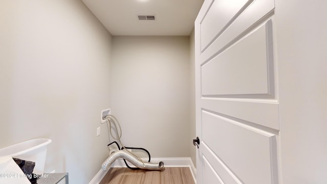 laundry area with hardwood / wood-style flooring and hookup for a washing machine