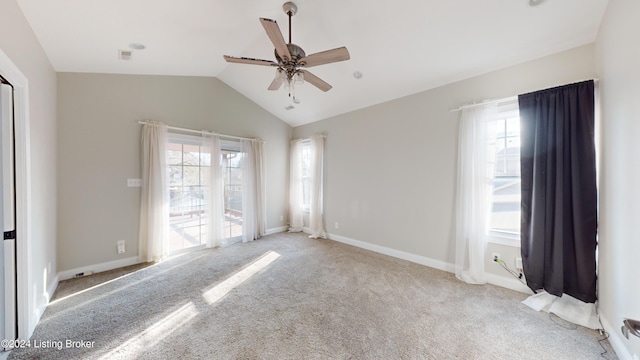 carpeted empty room with ceiling fan and vaulted ceiling