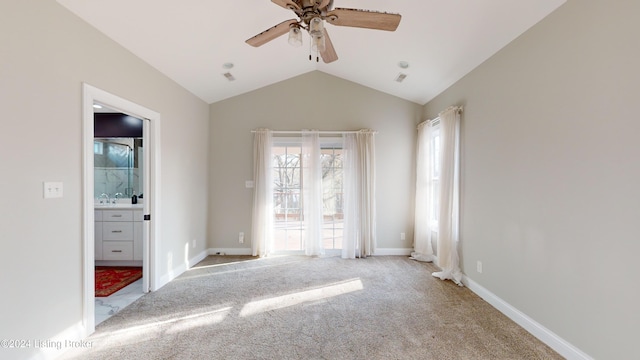 unfurnished room with ceiling fan, light colored carpet, and lofted ceiling