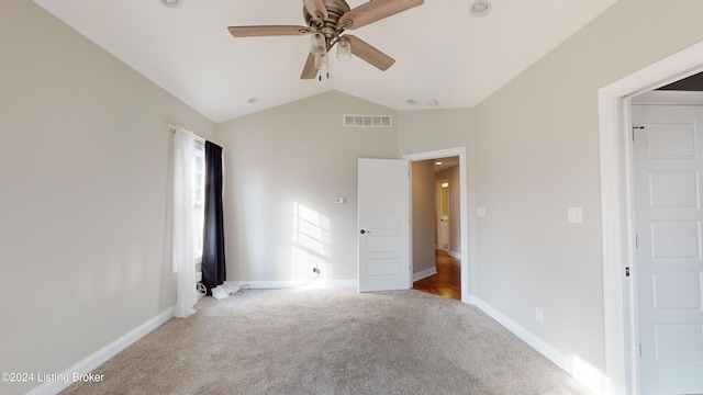 unfurnished bedroom featuring ceiling fan, light colored carpet, and vaulted ceiling