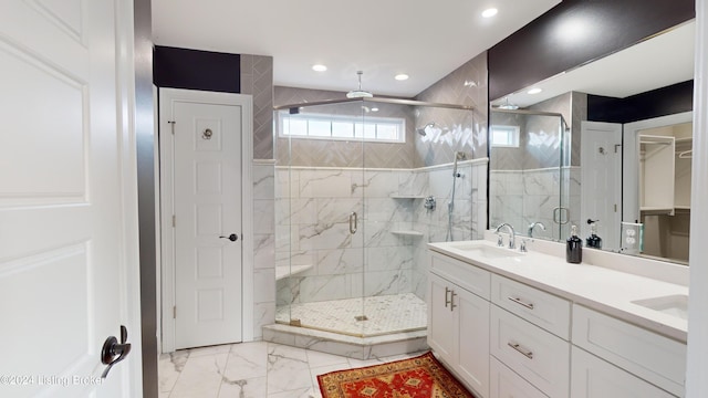 bathroom with vanity and a shower with shower door