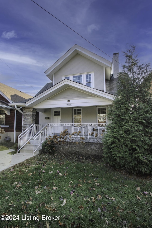 view of front facade with a porch and a front lawn