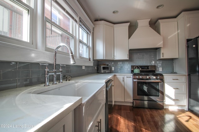 kitchen featuring black appliances, custom exhaust hood, dark hardwood / wood-style floors, and white cabinetry