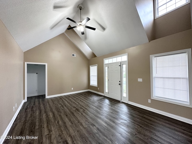 entrance foyer featuring ceiling fan, dark hardwood / wood-style flooring, a textured ceiling, and high vaulted ceiling