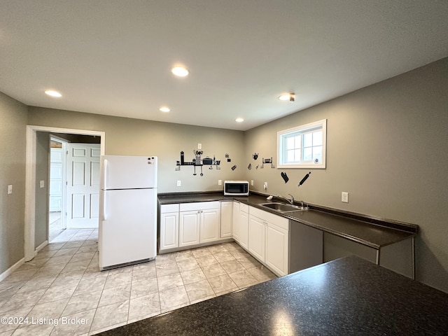 kitchen featuring white cabinets, white appliances, and sink