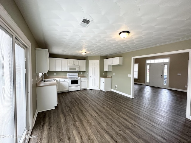 kitchen featuring dark hardwood / wood-style flooring, white appliances, a textured ceiling, sink, and white cabinetry