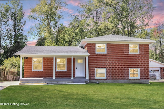 split level home featuring a yard