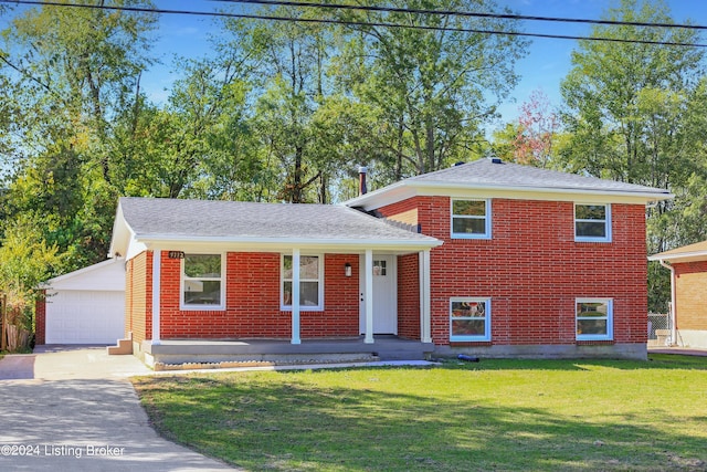 tri-level home featuring a garage, an outdoor structure, and a front lawn