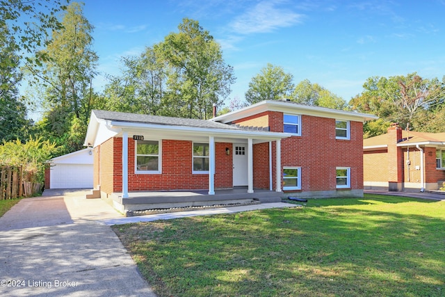 split level home featuring a front yard, a garage, an outdoor structure, and covered porch