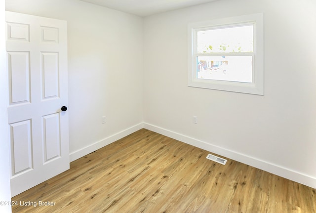 spare room with light hardwood / wood-style flooring