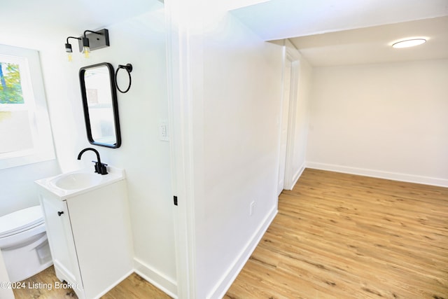 bathroom with vanity, toilet, and wood-type flooring