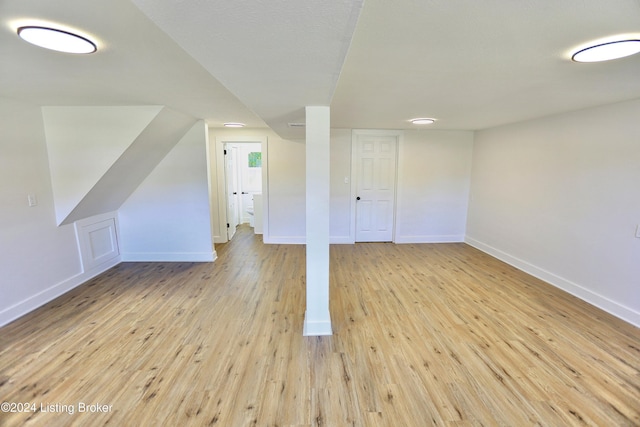 additional living space with light hardwood / wood-style floors