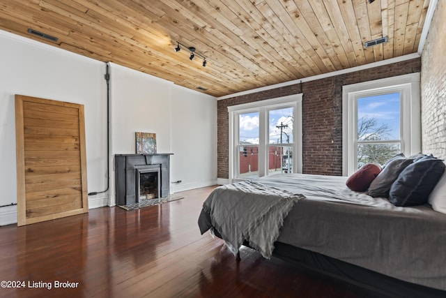 bedroom featuring wood-type flooring, ornamental molding, brick wall, and wooden ceiling